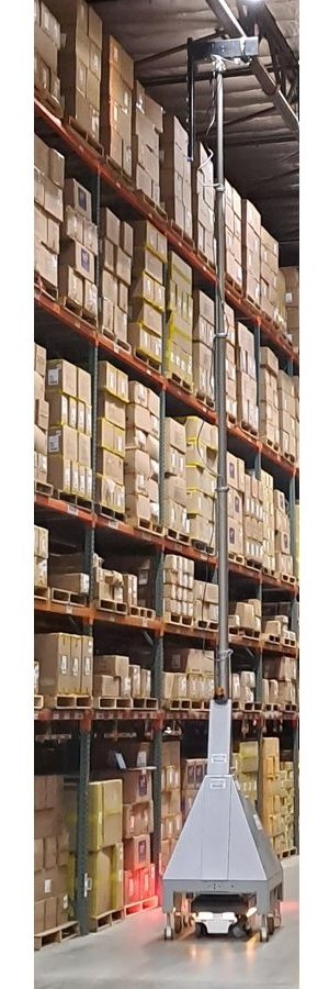 Barcode Bully robot working in a warehouse aisle between tall pallet racking